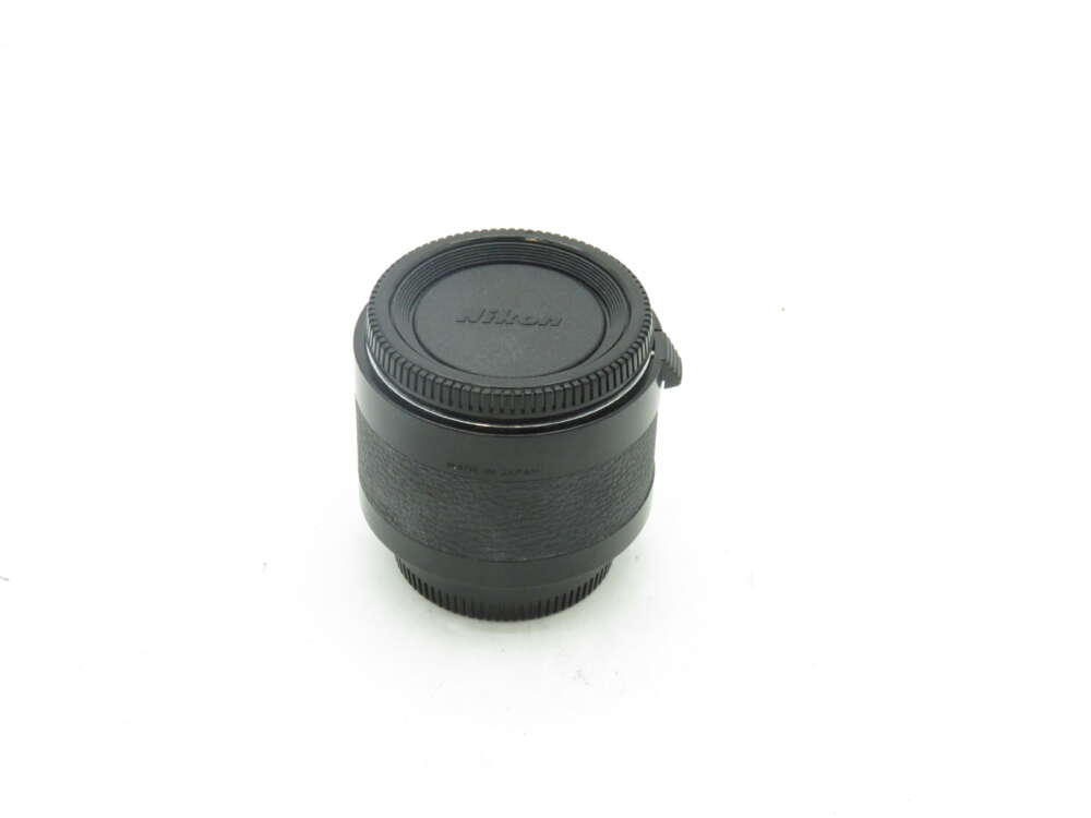 IMG_0693 A Nikon camera lens with a front and rear cap.
