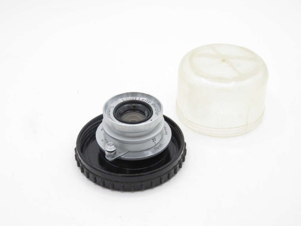 IMG_0129 Camera lens with protective cap and cover.