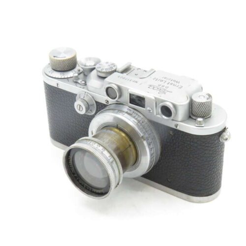 Vintage rangefinder camera with textured black body and silver details.