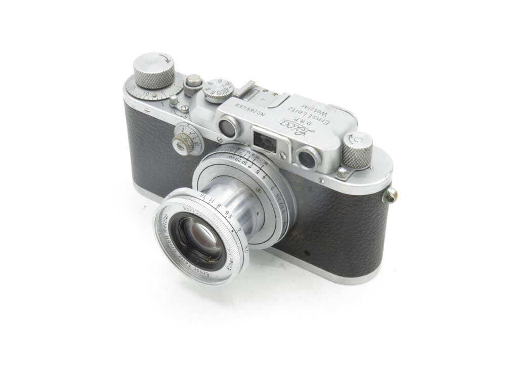 IMG_0253 Vintage Leica rangefinder camera with a silver body and black leatherette covering, featuring a collapsible lens.
