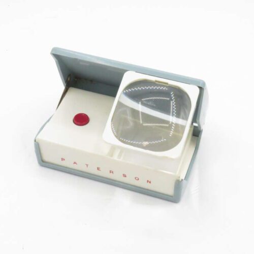 Vintage Paterson slide viewer with a magnifying lens and a red button, labelled with "PAT E R S O N".