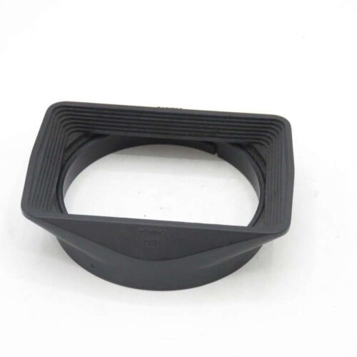 Rectangular black rubber lens hood for a camera.