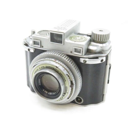 Vintage Kodak camera with Flash Supermatic shutter and Ektar lens in a silver and black finish.