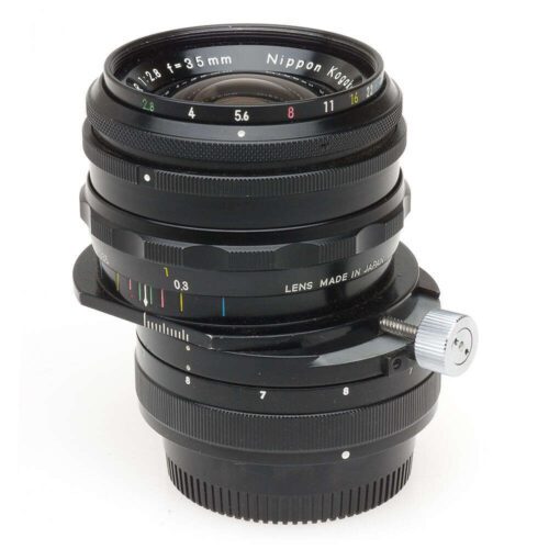 Black camera lens with "Nippon Kogaku" and "Lens made in Japan" text.