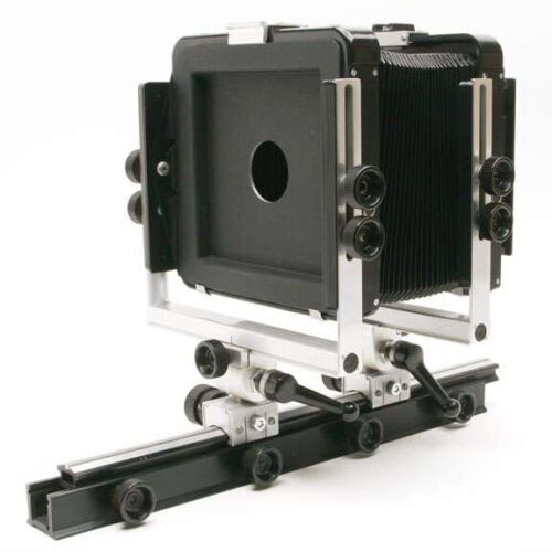 Large format view camera with a rail base and bellows.