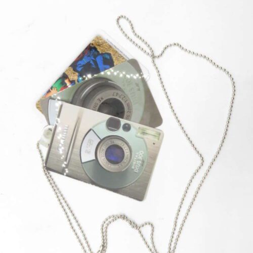 Keychain with metal beads and attached items resembling vintage digital cameras.