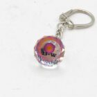Crystal keychain with a pink and orange circular design, labeled "B+W" attached to a silver metal clasp.
