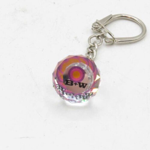 Crystal keychain with a pink and orange circular design, labeled "B+W" attached to a silver metal clasp.