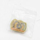 Yellow camera-shaped object with "SAMSUNG CAMERA" text, inside a clear plastic bag.