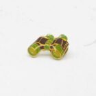 Green and yellow Pentax binocular pin.