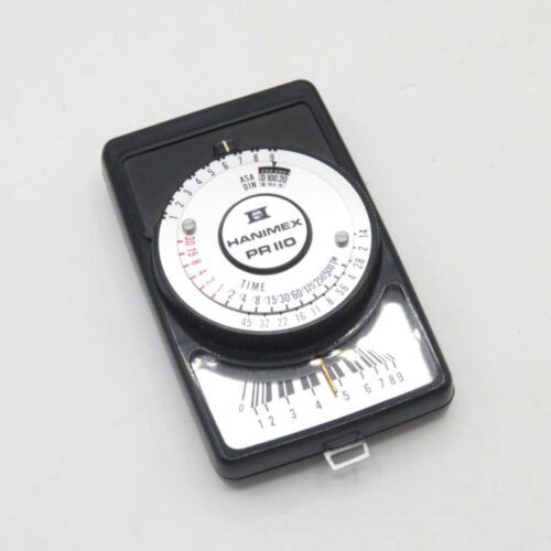 Vintage Hanimex PR 110 light exposure meter with central dial and black casing.