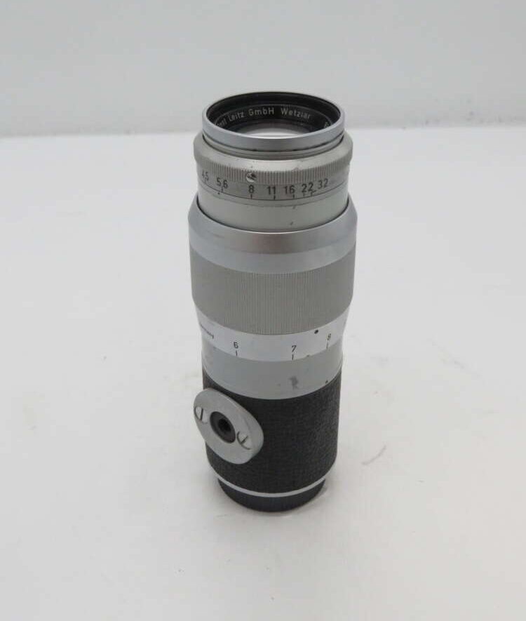 IMG_1151 Silver and black camera lens with engraved markings, featuring the text "Ernst Leitz GmbH Wetzlar" around the top and a focus dial.