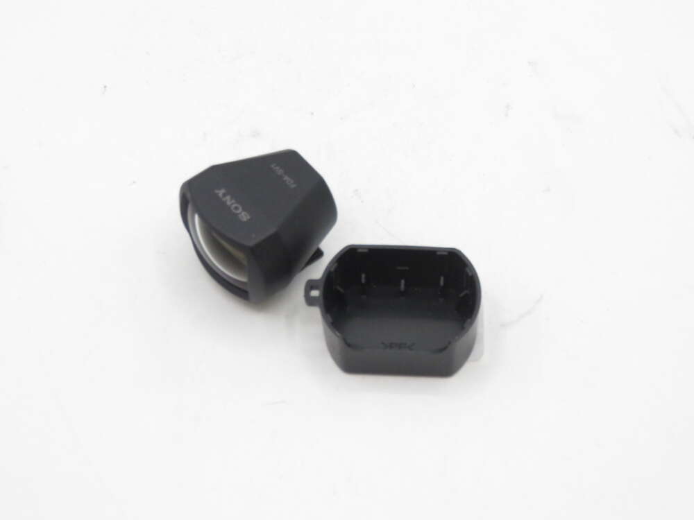 IMG_1326 Black Sony viewfinder attachment with cap on a white background.