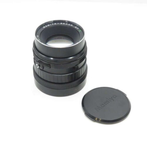 Black camera lens with "Mamiya-Sekor" inscription, accompanied by a detached lens cap.