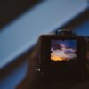 Camera viewfinder displaying a sunset with colourful clouds.
