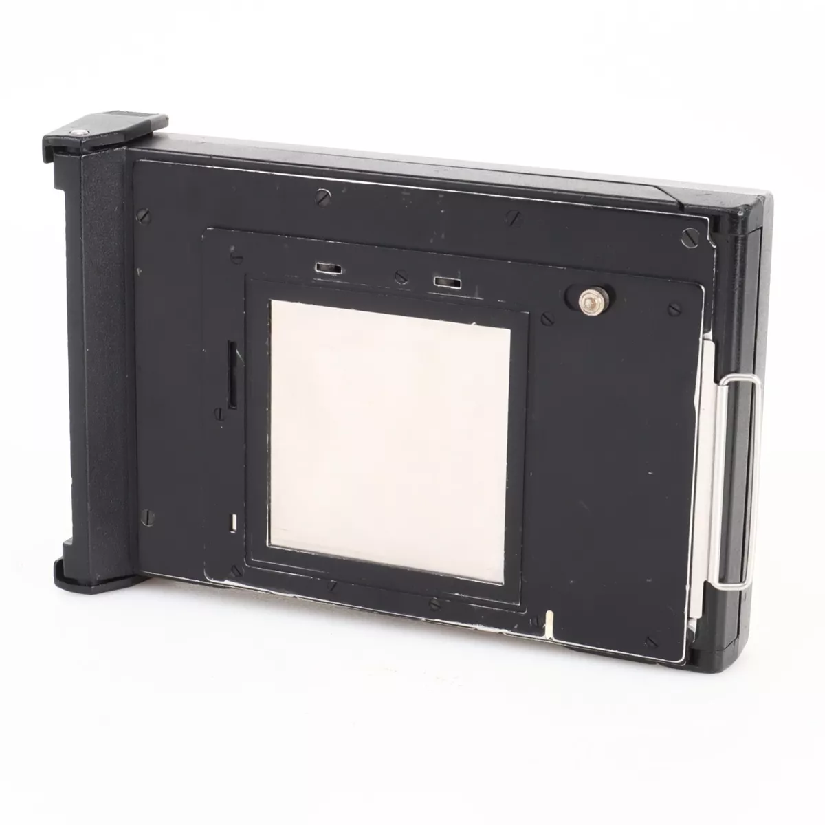 s-l1200 Black rectangular film holder for large format cameras with a central white rectangle, metal clip on the side and plastic frame.