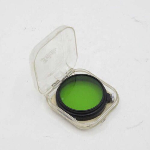 Green camera lens filter in a clear plastic case.