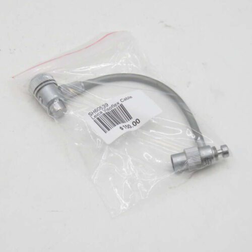 Small grey cable with metallic connectors on both ends, packaged in a clear plastic bag with a price tag and barcode label.