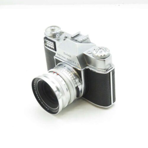 Kodak Retina Reflex S vintage camera with a silver metal body and black textured grip.