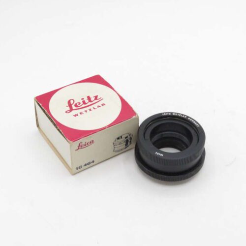 Leitz Wetzlar camera lens next to its original box.