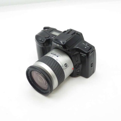 Minolta Dynax 3L film camera with a silver lens on a white background.