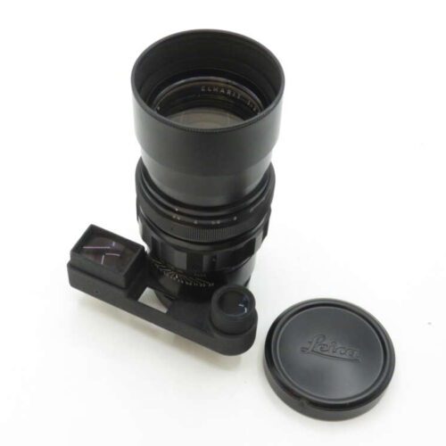 Telephoto camera lens with lens cover and attached rangefinder, with Leica logo on the cover, placed on a white background.