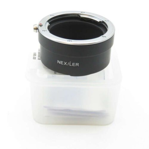Camera lens mount adapter labelled "NEX/LER" placed on a plastic container.
