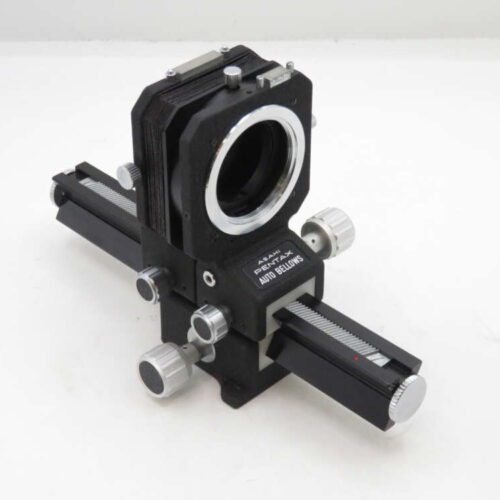 Vintage Asahi Pentax Auto Bellows camera accessory with a black and silver design, featuring adjustable knobs and slide rails.