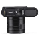 Bottom view of a Leica camera showing various labels, connector ports, and a lens.
