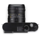 Top view of a camera with a large lens and various dials.