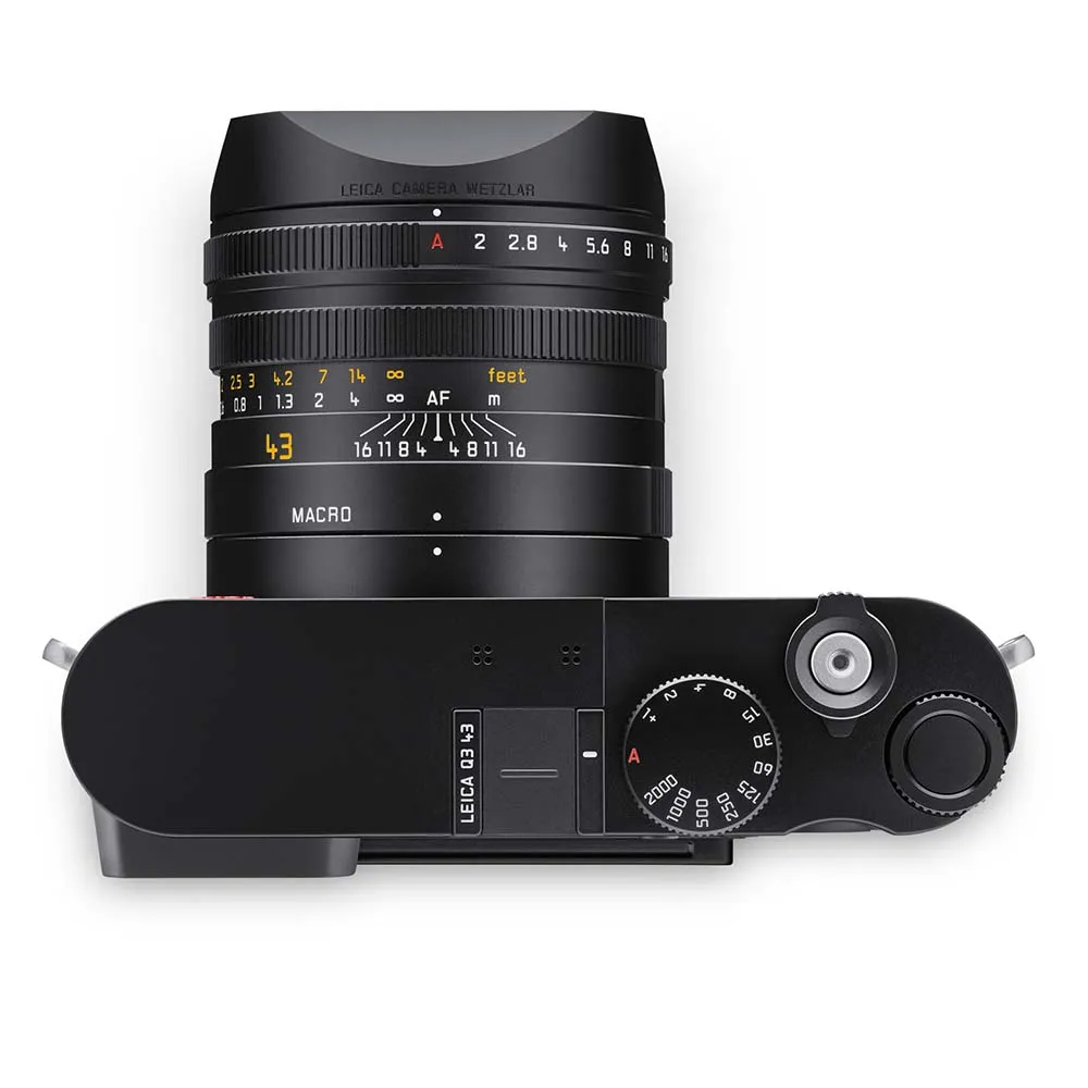 Top view of a camera with a large lens and various dials.