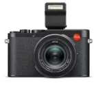 A black Leica camera with a pop-up flash and a textured grip.