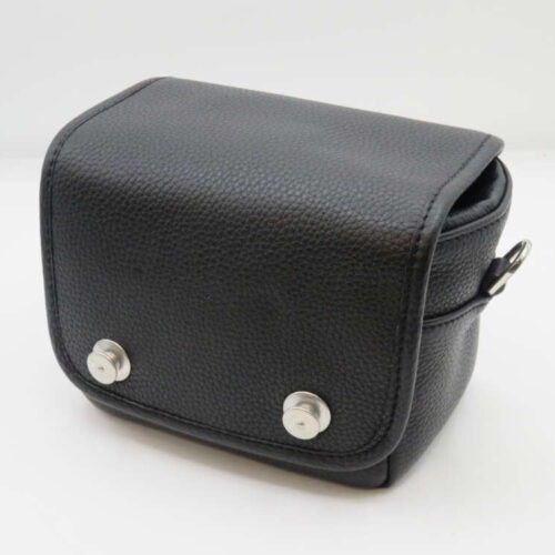 Black leather camera bag with metal studs, viewed at an angle.