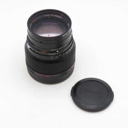 Medium format camera lens with a 150mm focal length and accompanying lens cap, displayed on a white background.