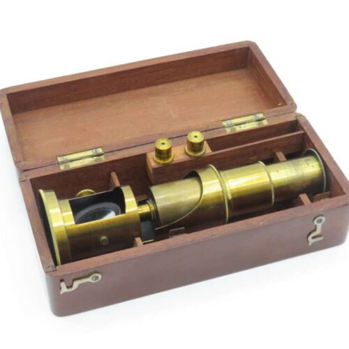 Brass telescope in a wooden case with two smaller cylindrical attachments.