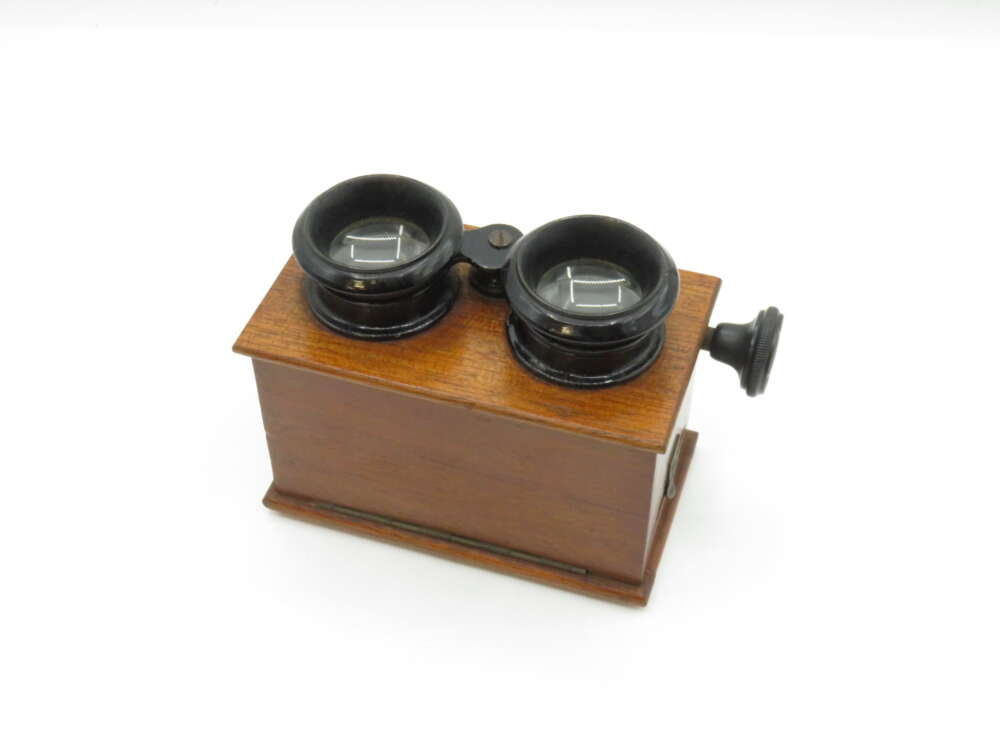 IMG_2997 Antique stereoscope with wooden body and dual lenses.