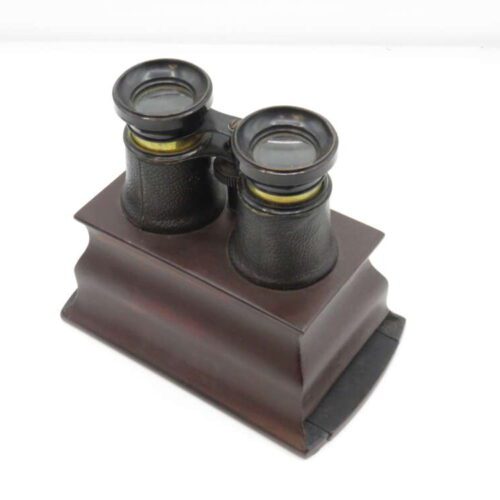 Vintage binoculars on a wooden stand.