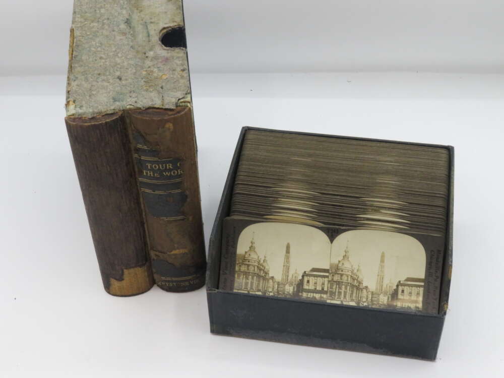 IMG_3006 Two vintage books titled "Tour of the World" next to a box of stereoscopic cards featuring architectural images.