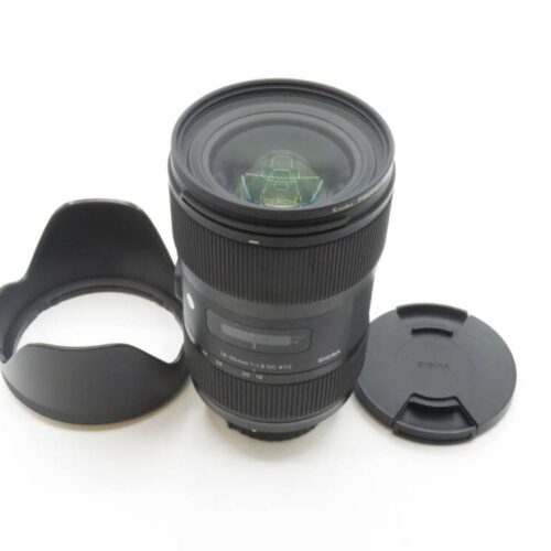 Camera lens with hood and cap on a white background.