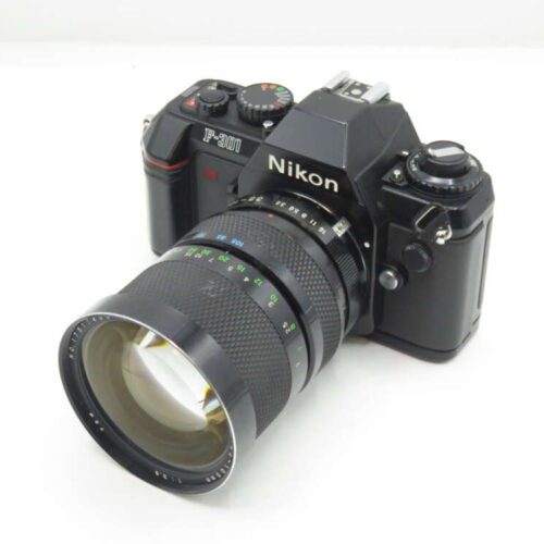 A Nikon F-301 film camera with an attached zoom lens.