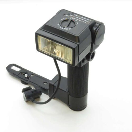 Vintage handheld camera flash with a bracket and adjustable settings.