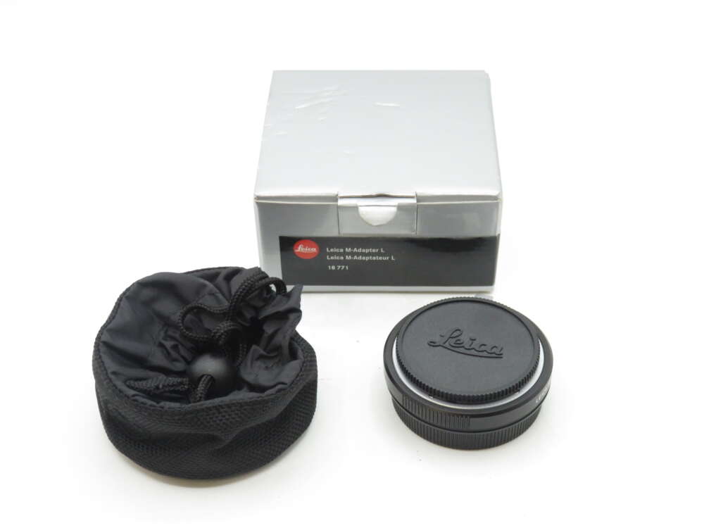 IMG_0101 A Leica M-Adapter L with its black protective pouch and box; the adapter has the Leica logo on it.
