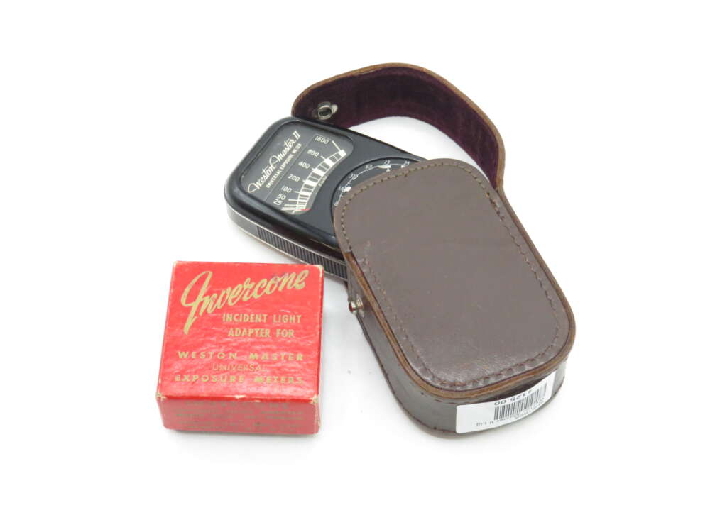 IMG_0102 A Weston Master II exposure meter in a brown leather case with a red box labeled Invercone, an incident light adapter for exposure meters, sitting beside it.
