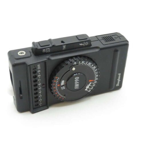 Alt text: Vintage Shepherd FM990 photographic light meter with dials and settings.