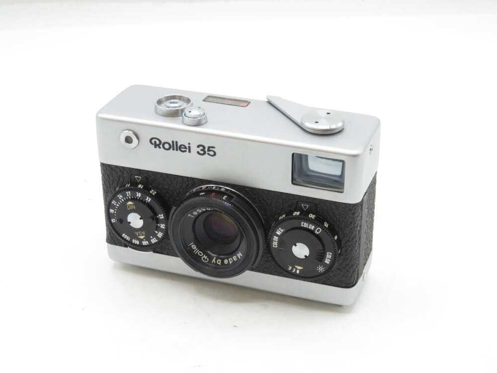 IMG_0400 A vintage Rollei 35 camera with a silver top and black body, featuring dials for settings and a lens prominently in the front.
