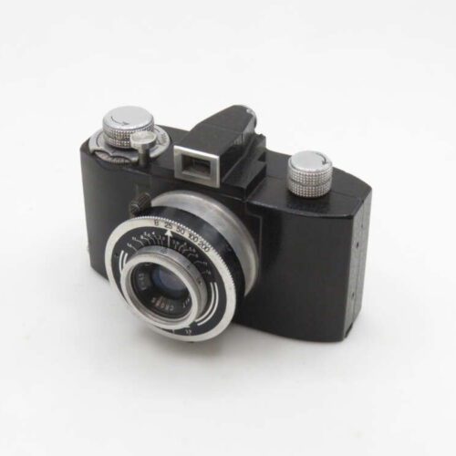 A vintage black box camera with a silver lens and knobs, featuring a viewfinder on top, set against a white background.