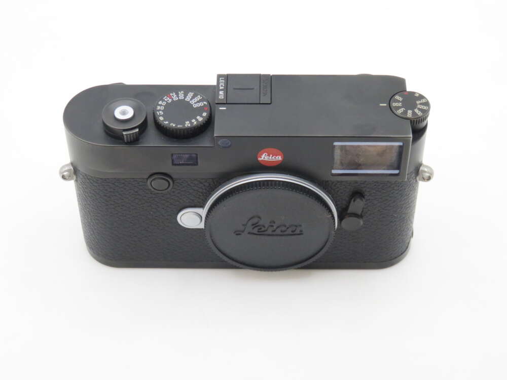 A black Leica rangefinder camera with a classic design, featuring manual dials on the top, and the Leica logo above the lens mount.