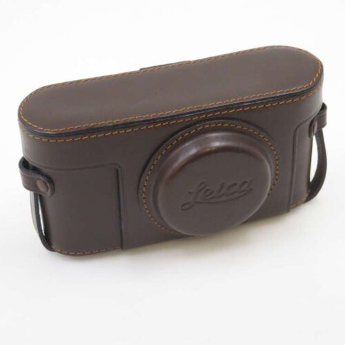 A brown leather camera case with stitching and the word 'Leica' embossed on the front.