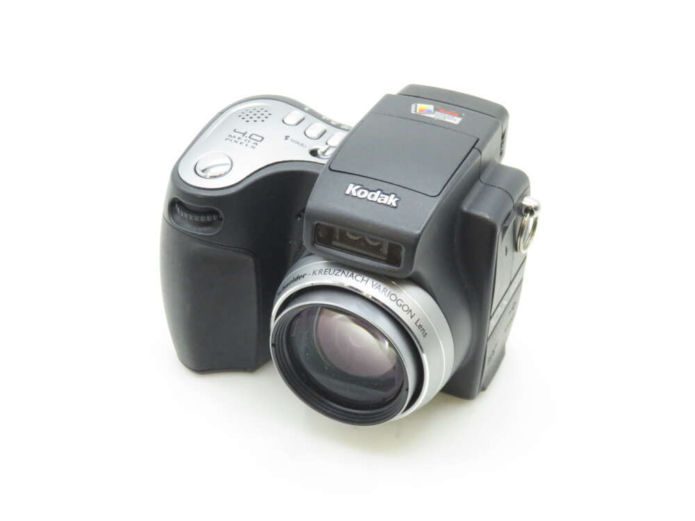 IMG_0923 A Kodak digital camera with a prominent lens and a black and silver design, featuring various control buttons on the top panel.