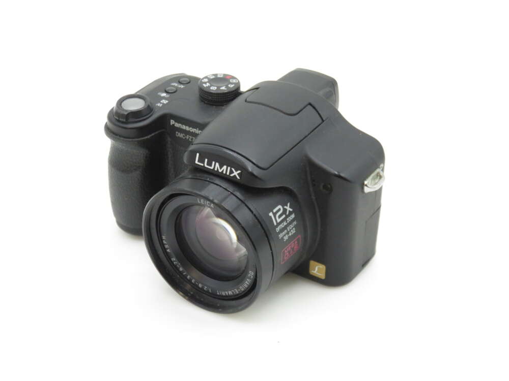IMG_1127 A Panasonic Lumix DMC-FZ8 digital camera with a 12x optical zoom lens and Leica lens branding, featuring a black body and an ergonomic design with control buttons and dials on the top.